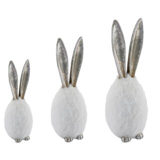 dekoratives originelles Osterei als Plüschei mit Hasenfüßen und langen Hasenohren